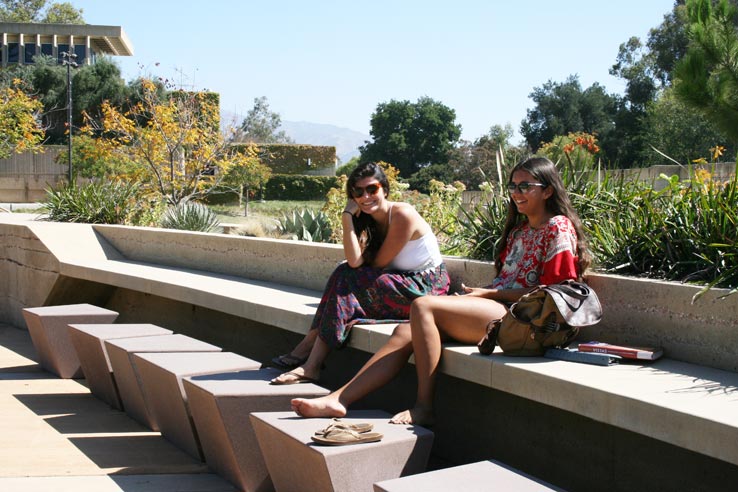 Two students sitting outside.